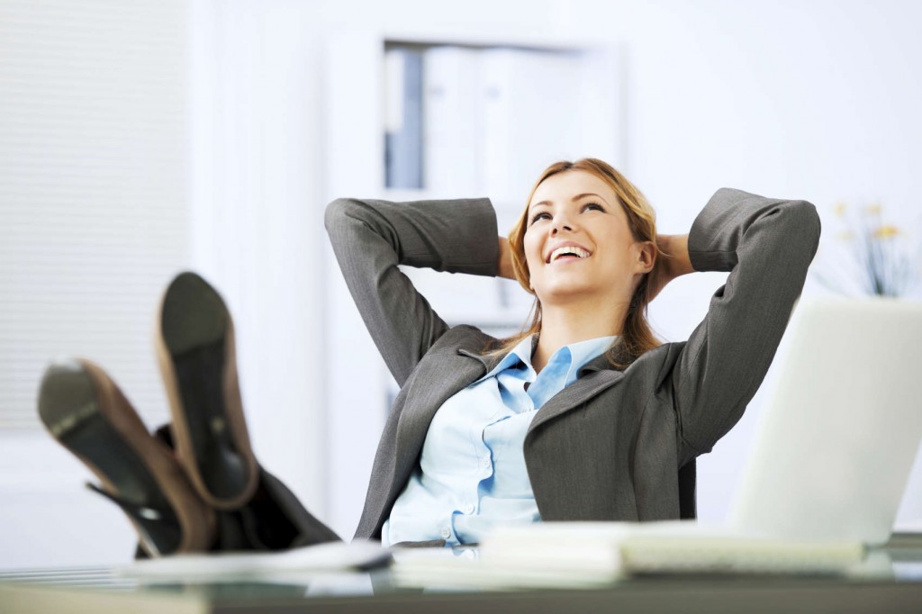 Young business woman  daydreaming in the office with feet on the table.  [url=http://www.istockphoto.com/search/lightbox/9786622][img]http://dl.dropbox.com/u/40117171/business.jpg[/img][/url]